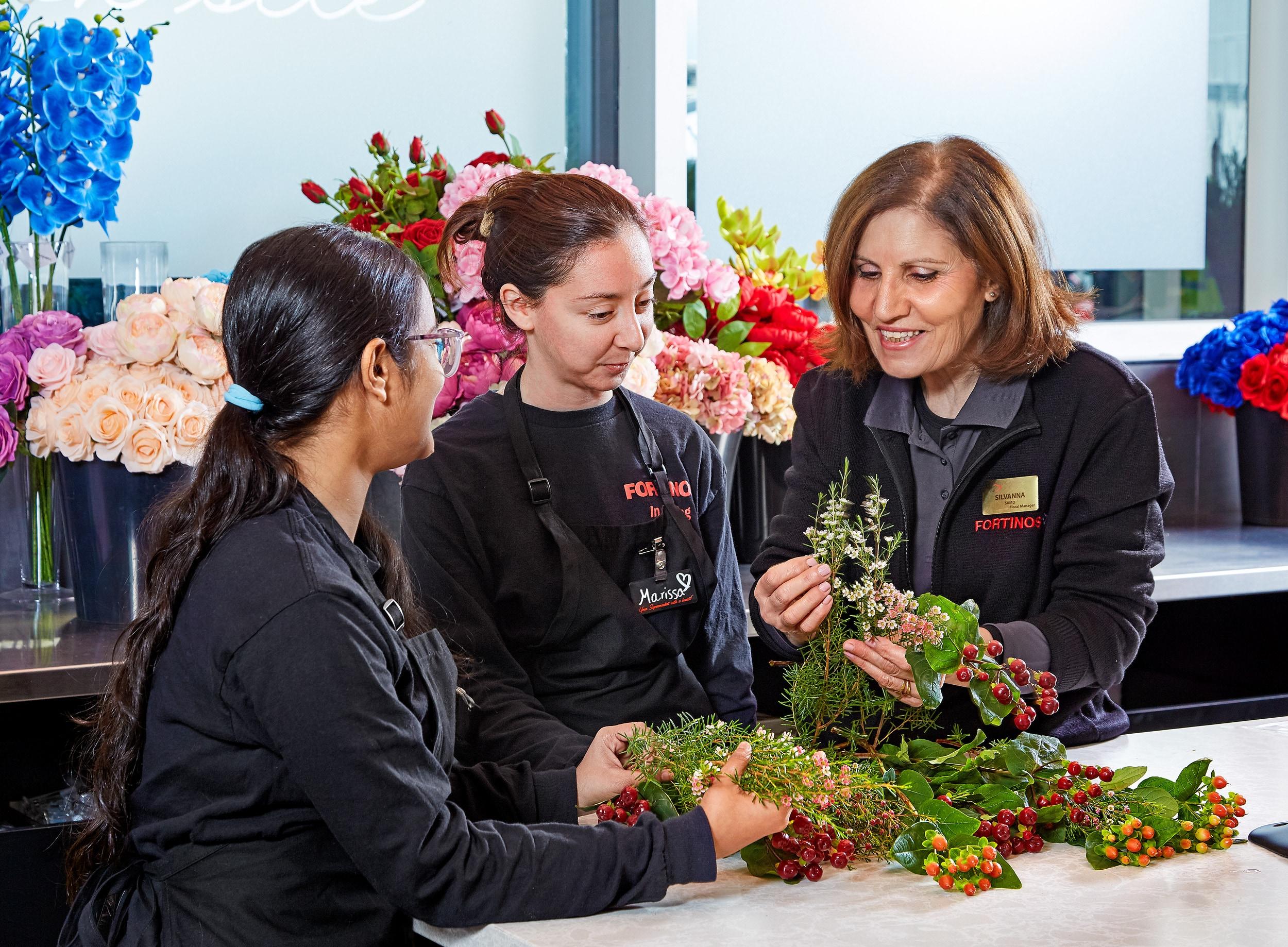 Three Flowers by Fortinos floral designers handling fresh cut flowers.
